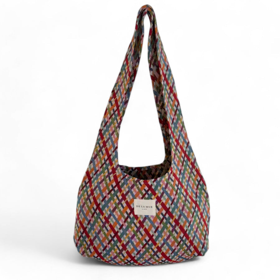 Bolsa ovalada con estampado jacquard multicolor, vista frontal.