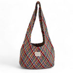 Bolsa ovalada con estampado jacquard multicolor, vista frontal.