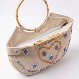 Imagen 3: Vista en perspectiva del bolso vintage con asas redondas de bambú.