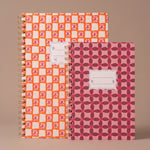 Libretas Orange Check y Pinwheel Pink juntas mostrando sus diseños de portada.