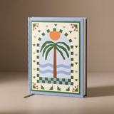 Cuaderno de tapa dura Palm Beach con ilustración de palmeras y paisaje mediterráneo.
