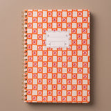 Vista de la portada de la libreta A4 Orange Check con tapa blanda de papel texturizado.