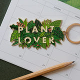 Llavero Plant Lover de All The Ways To Say sobre calendario ilustrado con plantas.