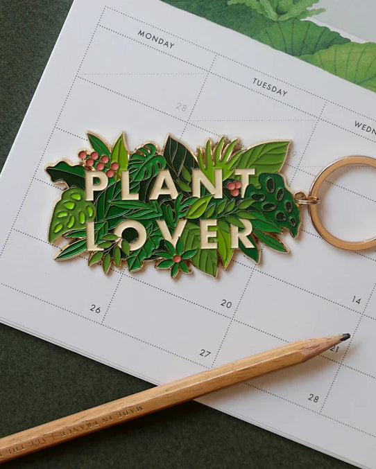 Llavero Plant Lover de All The Ways To Say sobre calendario ilustrado con plantas.
