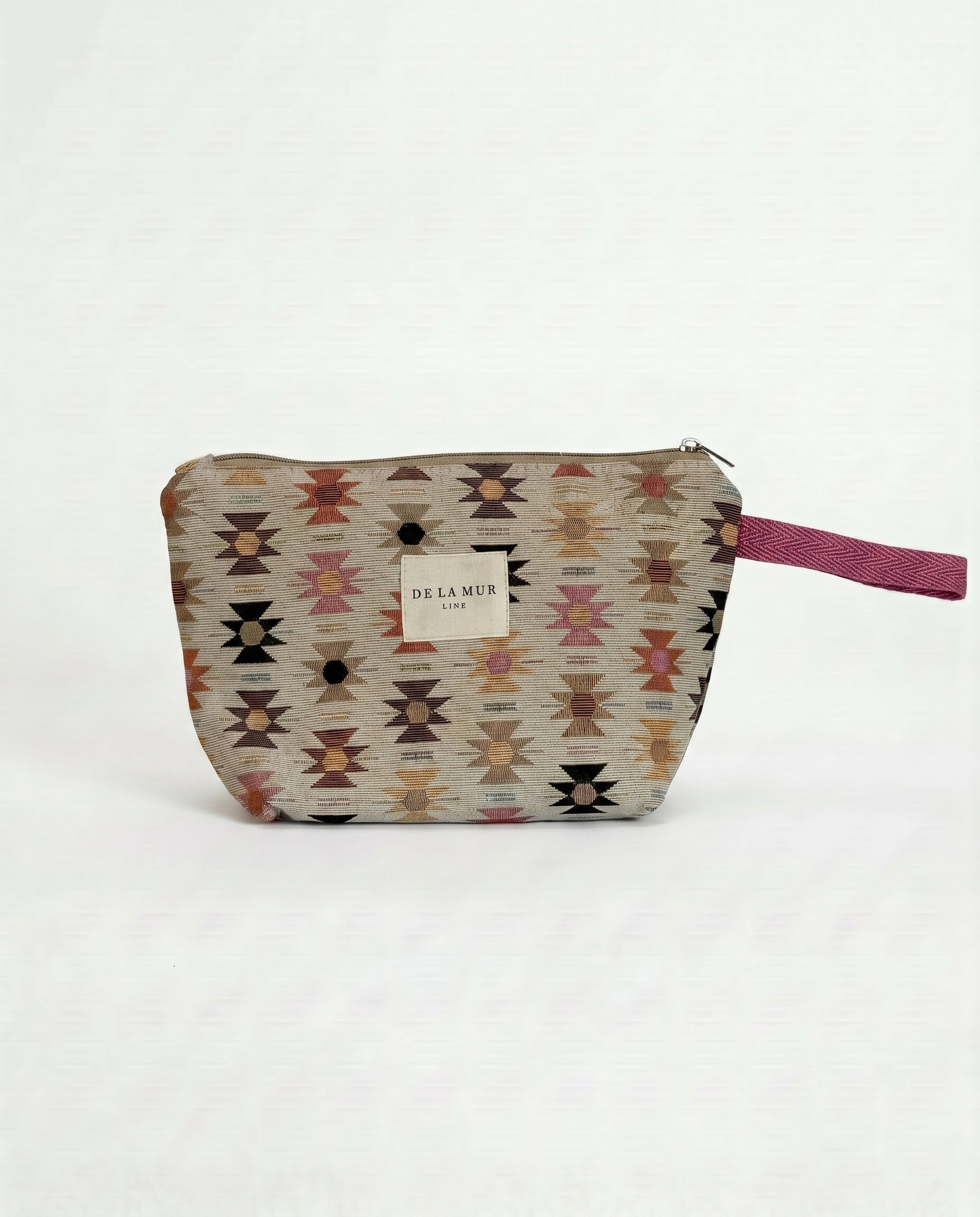 Neceser de jacquard con estampado geométrico y cierre de cremallera.
