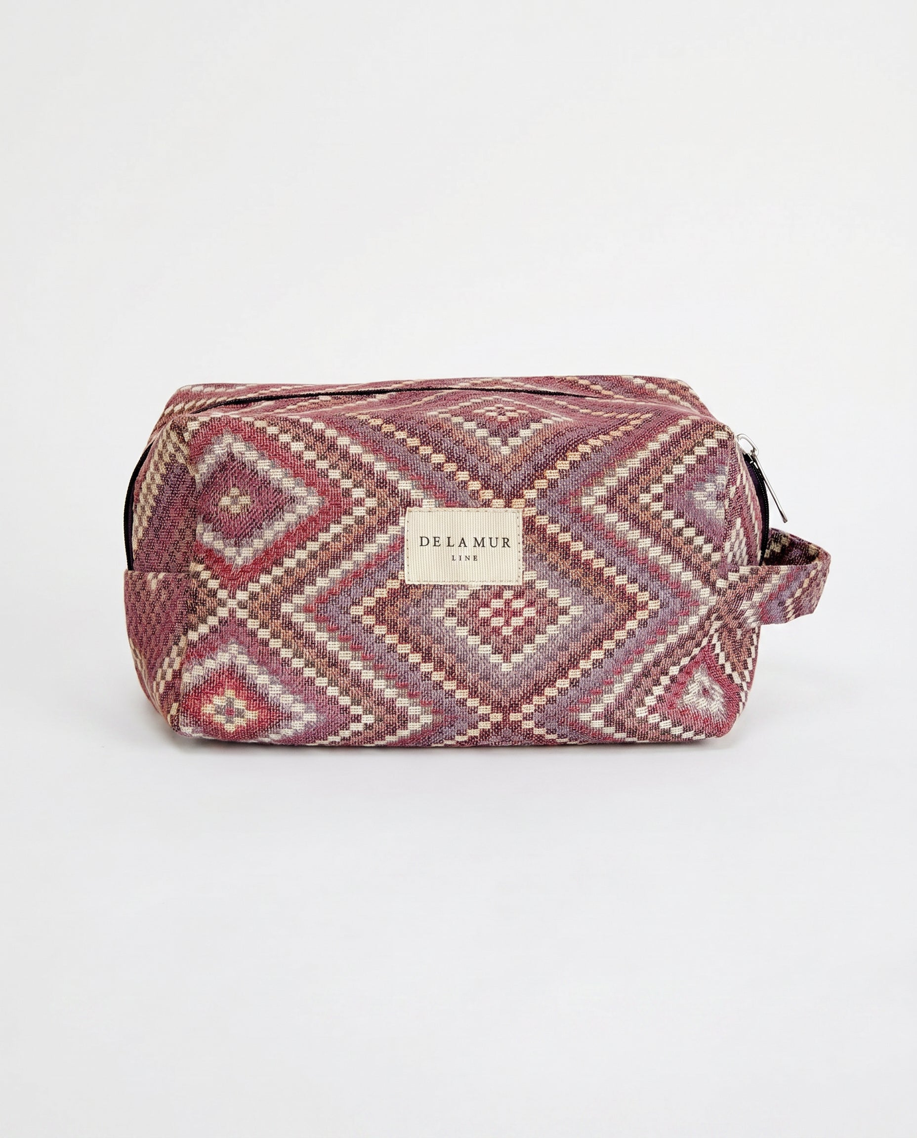Neceser de jacquard con estampado de rombos en tonos rosa, lila y beige, vista frontal.