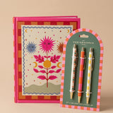 Pack de papelería A Dopo con cuaderno ilustrado y set de bolígrafos de diseño.