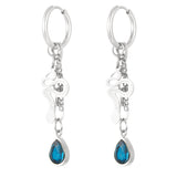 Pendientes plateados con charm de serpiente y piedra azul en forma de lágrima, vista frontal.

