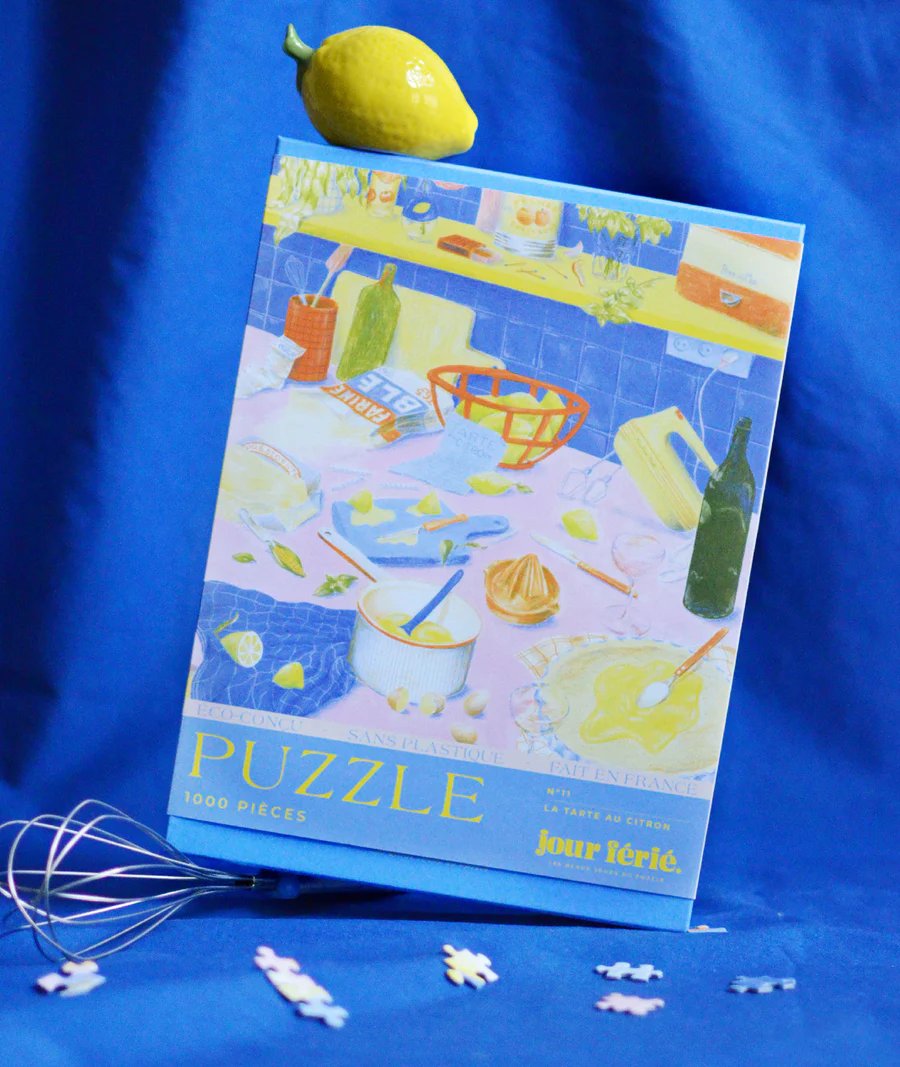  Caja del Puzzle Tarta de Limón con diseño minimalista y letras en amarillo y azul.