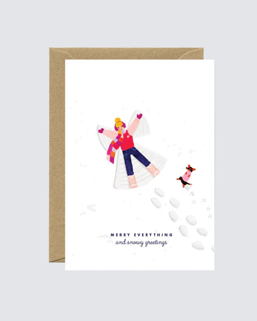 Tarjeta navideña con ilustración de persona haciendo un ángel en la nieve y un perro.