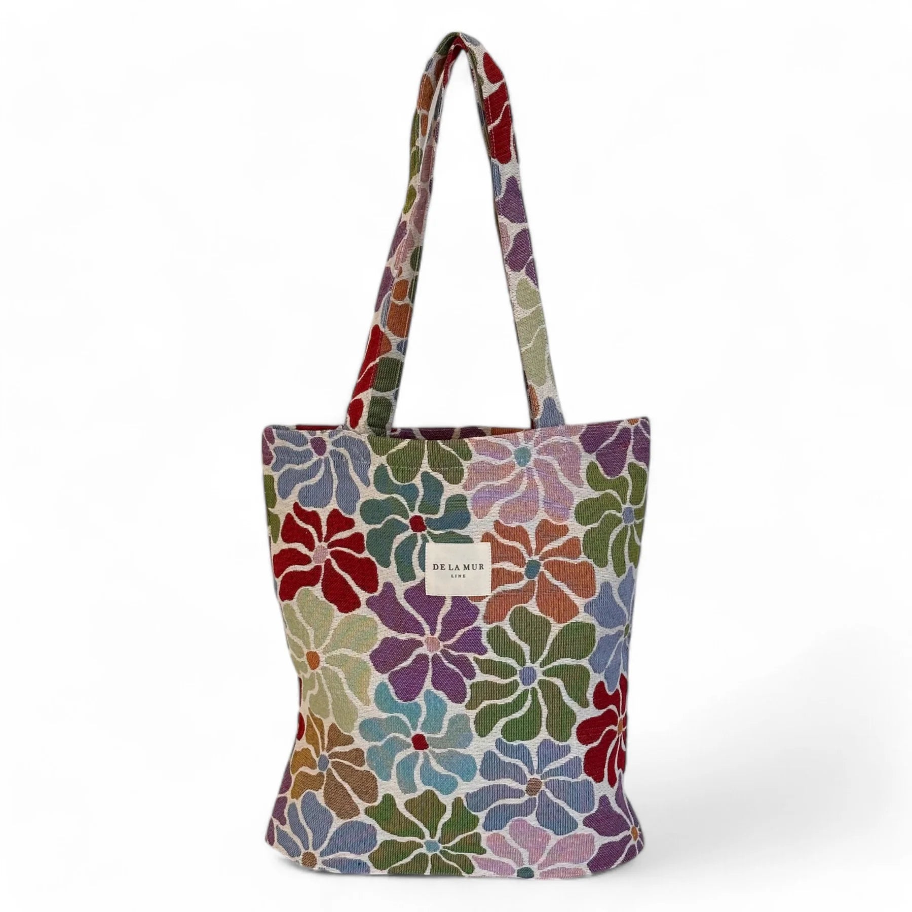 Tote bag con estampado floral multicolor en tejido de jacquard, vista frontal.